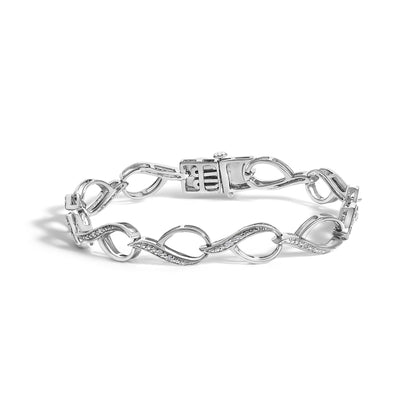White bracelet with linked open oval shapes, each decorated with small round white gemstones in prong settings, shown in a front angle view on a white background.