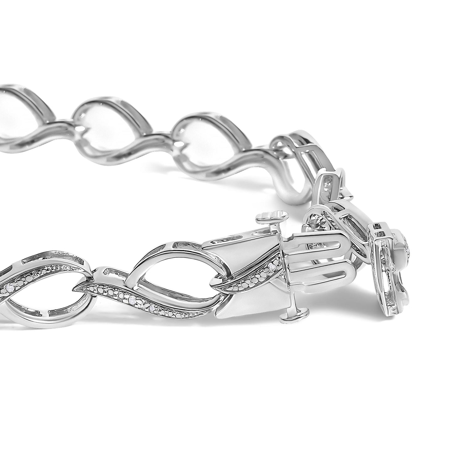 Close-up image of a white metal bracelet with round white gemstones in prong settings, shown angled with a portion of the clasp visible.