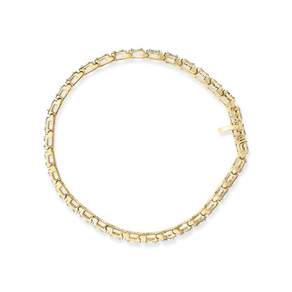 Top-down view of a yellow metal bracelet with round white gemstones in a miracle setting forming a continuous loop.
