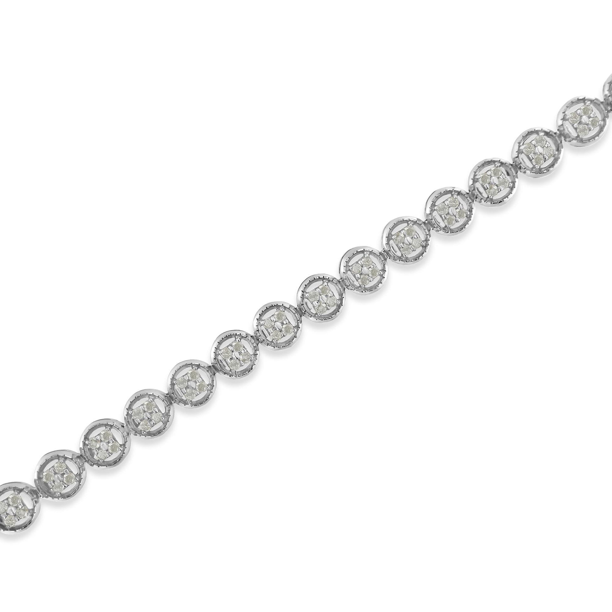 Diagonal close-up of a white metal bracelet featuring round white gemstones in prong settings arranged in circular clusters.