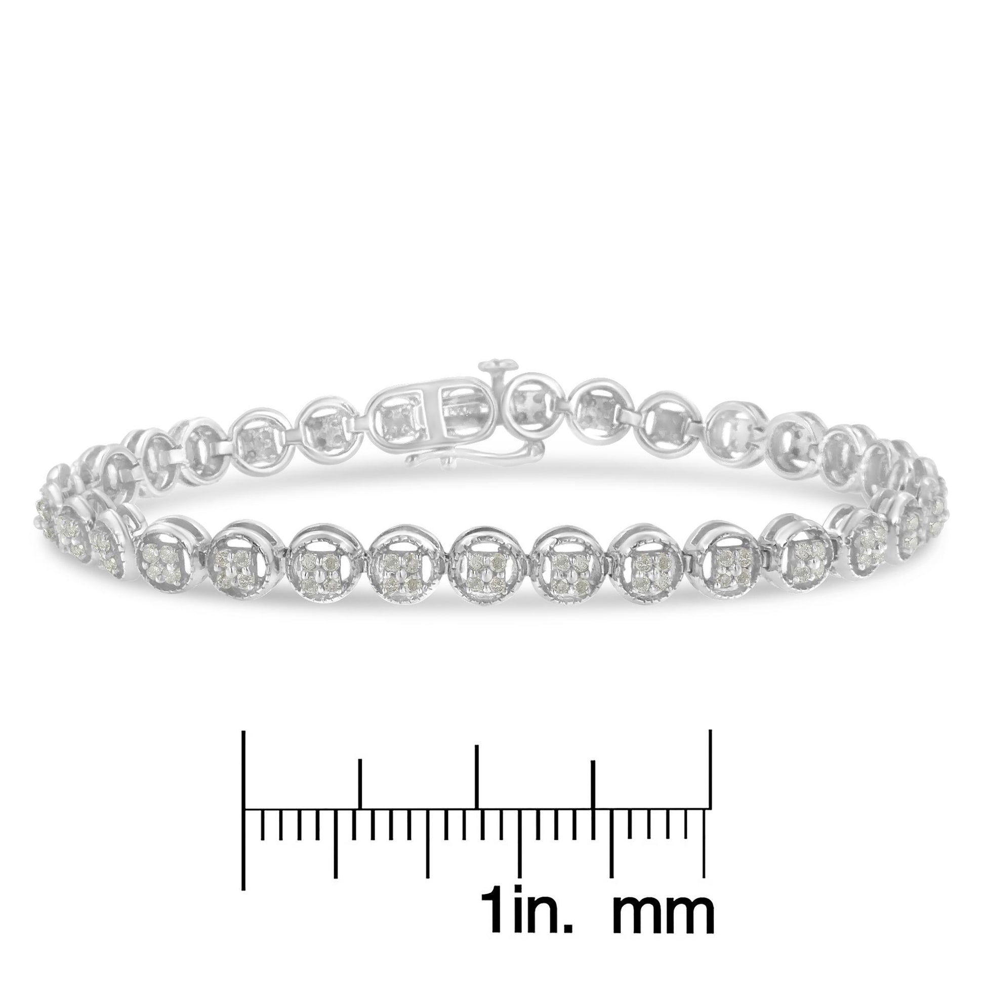 White metal bracelet with round white gemstones in prong setting, shown in a close-up front angle, placed above a ruler for size reference.