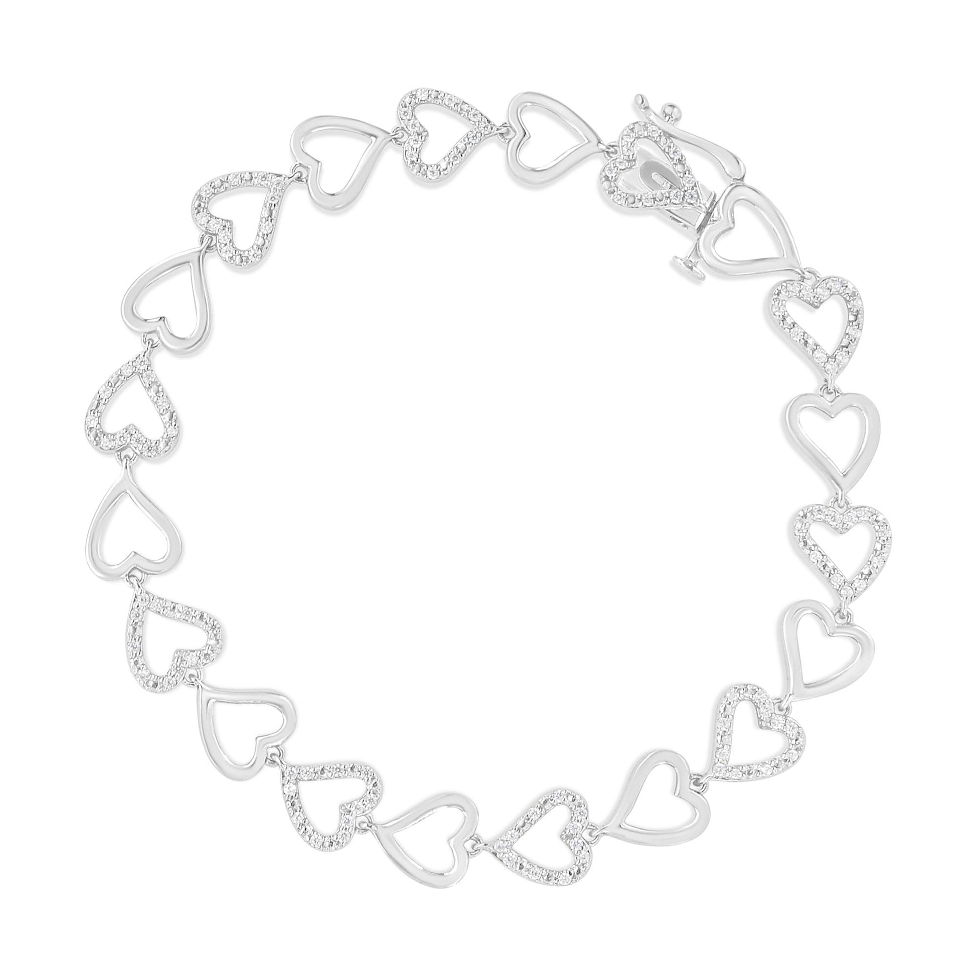 Top-down view of a white metal bracelet featuring alternating open heart shapes with prong-set round white gemstones.