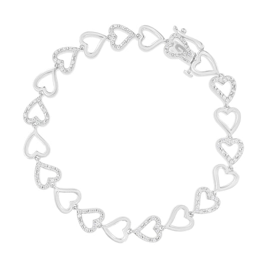 Top-down view of a white metal bracelet featuring alternating open heart shapes with prong-set round white gemstones.