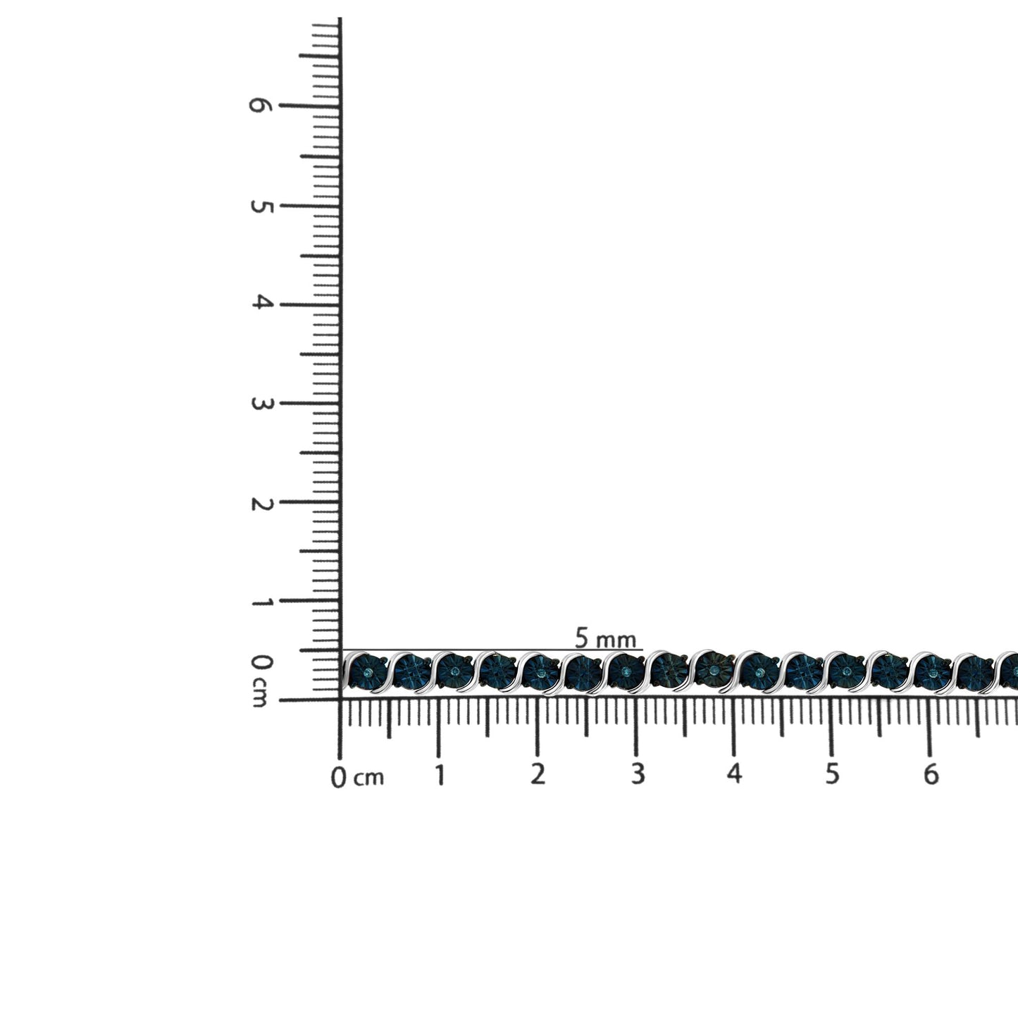 White metal bracelet with round blue gemstones in miracle setting, displayed horizontally on a ruler for size reference, image captured from a top-down angle.