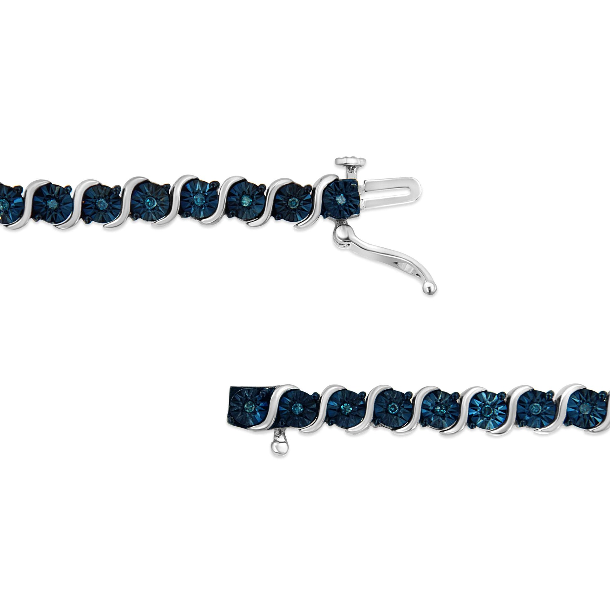 Close-up image of a white metal bracelet with round blue gemstones in a miracle setting, shown from the top angle with the clasp visible.