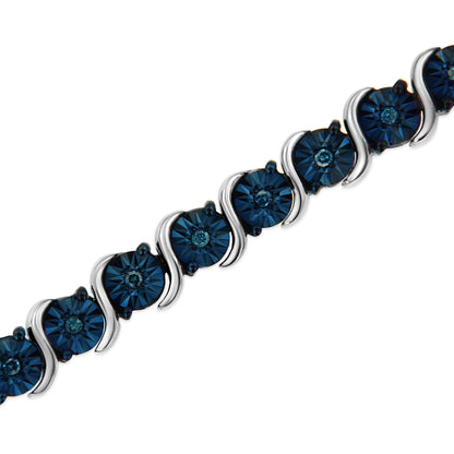 White bracelet with round blue gemstones in miracle setting, shown in a close-up diagonal angle.