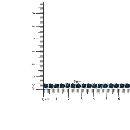 White metal bracelet with round blue gemstones in miracle settings laid flat on a ruler for size reference, top-down angle.