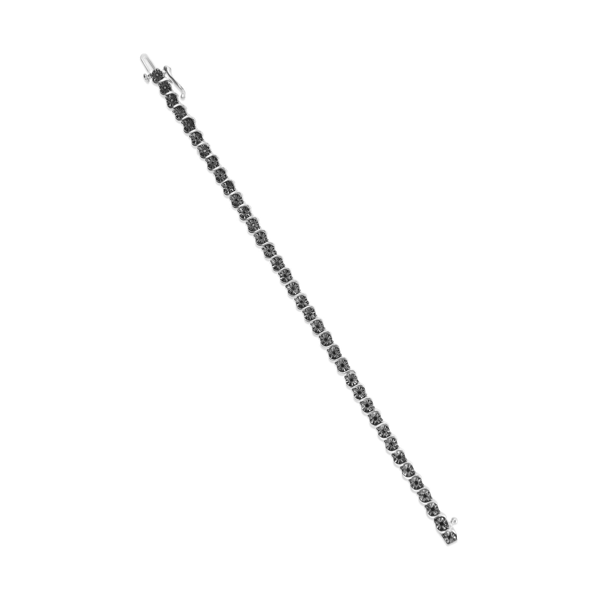 White bracelet with round black gemstones in miracle setting, shown in a flat lay angled view.