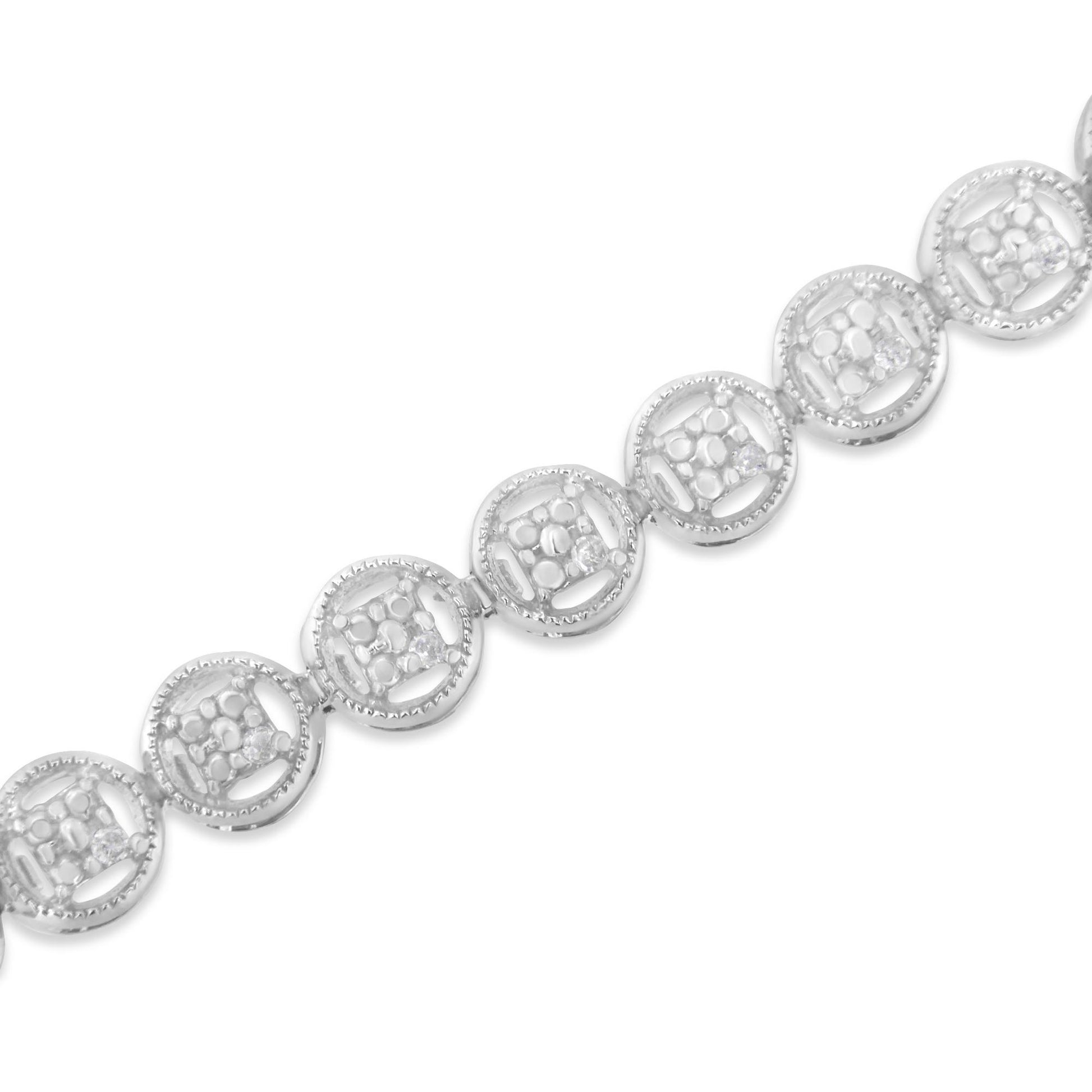 Close-up diagonal shot of a white metal bracelet featuring circular links with round white gemstones in prong settings.