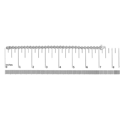 White metal bracelet with round white gemstones in prong settings, displayed flat on a ruler for size reference, shot from above.
