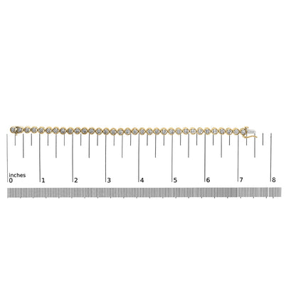 Straight top-down view of a yellow bracelet with white round gemstones in prong settings, placed on a ruler for size reference.