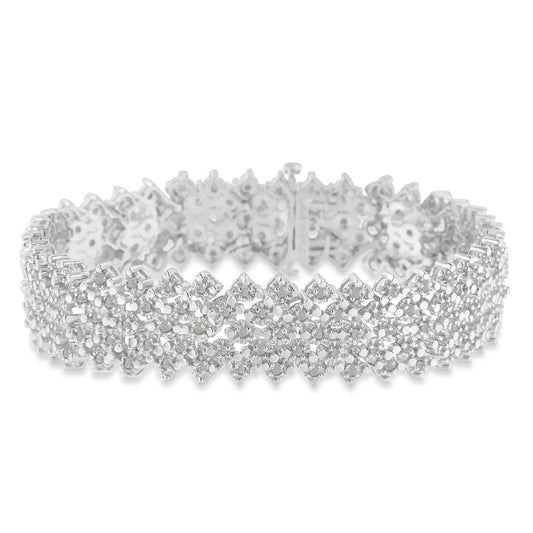 Close-up view of a white metal bracelet with round white gemstones in prong settings, arranged in a floral pattern.
