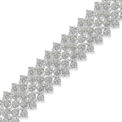 Close-up of a white metal bracelet with round white gemstones in prong settings, shot at an angle.