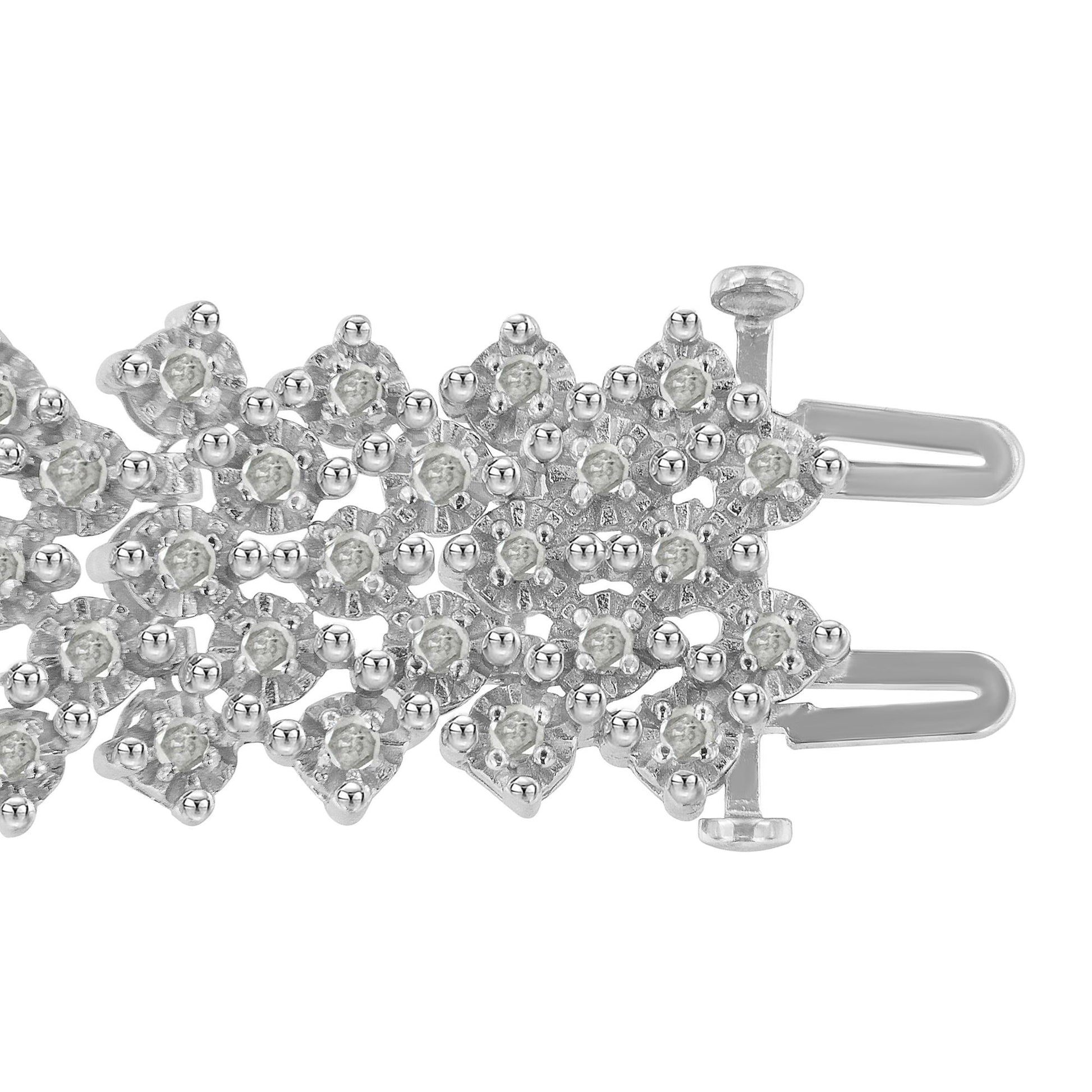 Close-up top view of a white metal bracelet section featuring round white gemstones in prong settings arranged in a detailed, overlapping pattern with a visible clasp mechanism.