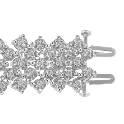 Close-up top view of a white metal bracelet section featuring round white gemstones in prong settings arranged in a detailed, overlapping pattern with a visible clasp mechanism.