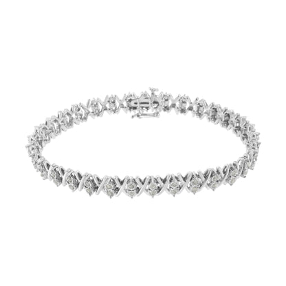 White metal bracelet with round white gemstones in a miracle setting, shown from a top angled view.