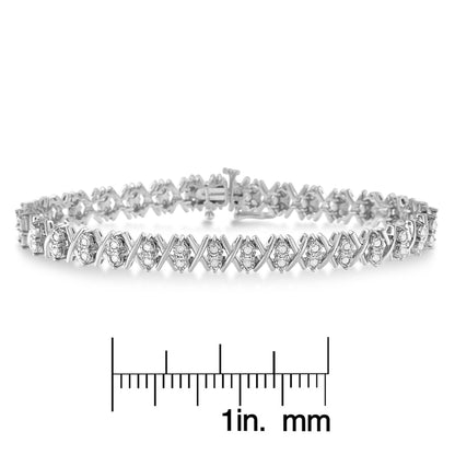 Bracelet with white metal and round white gemstones in a crisscross pattern, shown in a front angle on a ruler for size reference.