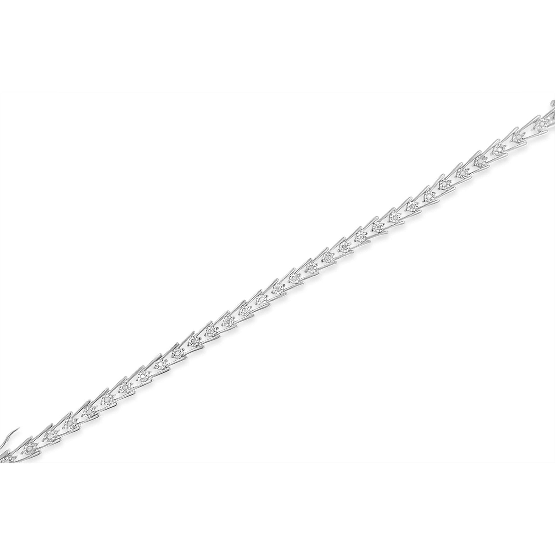White metal bracelet with round white gemstones in miracle setting, shown in a diagonal flat lay angle.