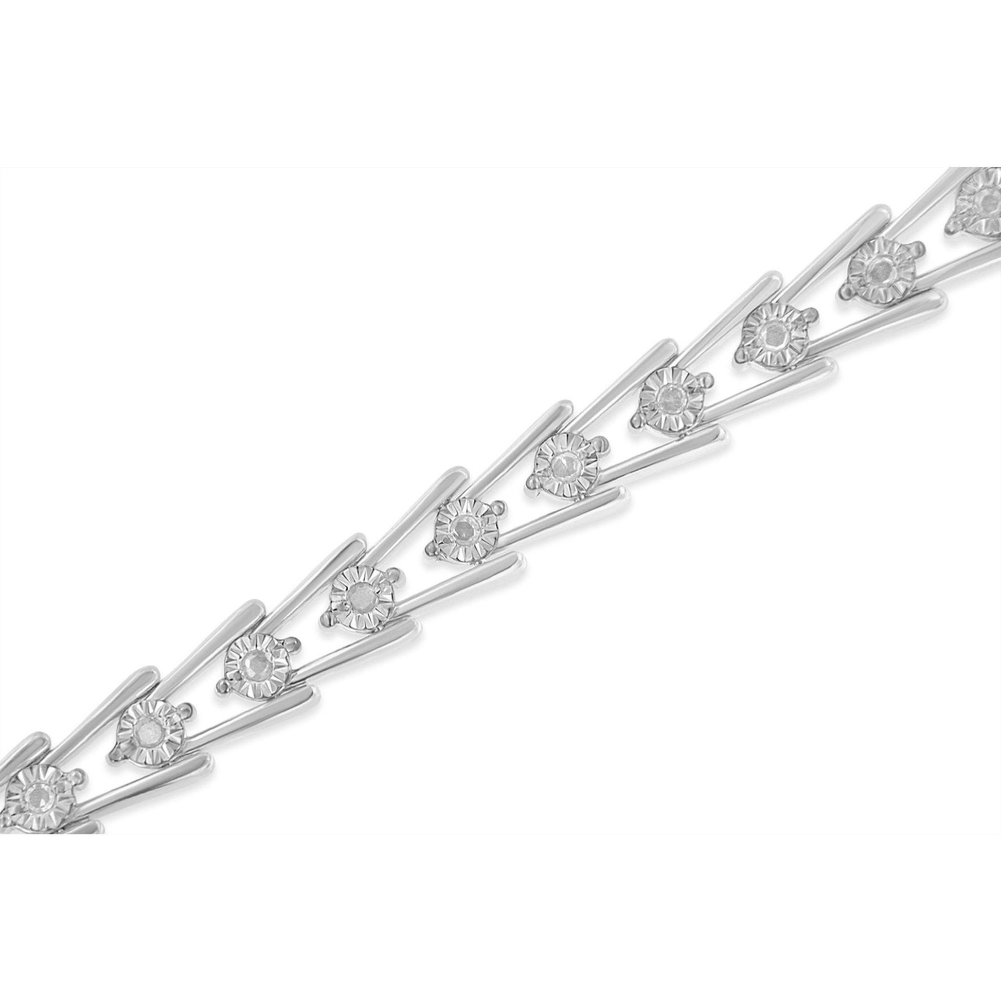 Close-up angled view of a white metal bracelet featuring round white gemstones in a miracle setting.