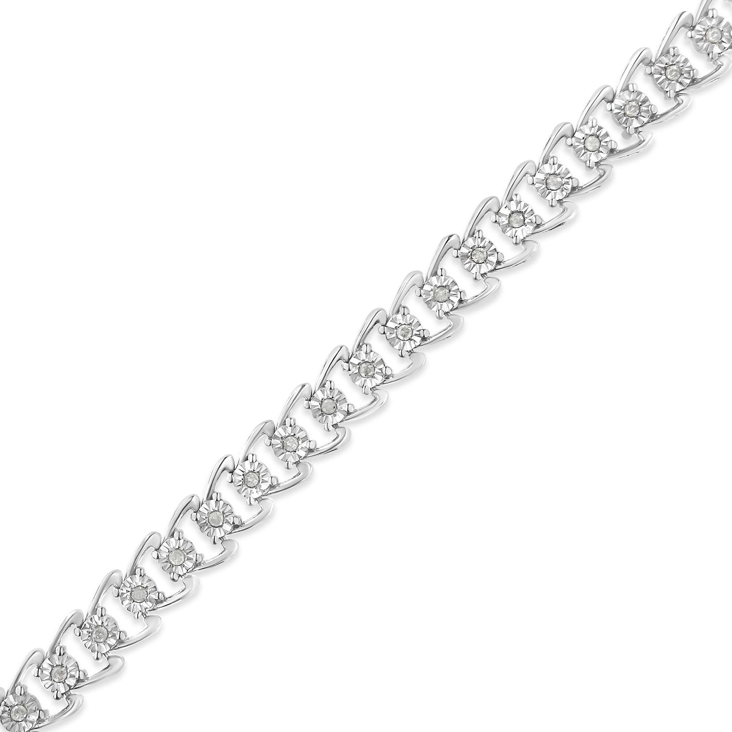 Close-up diagonal view of a white metal bracelet featuring round white gemstones in a miracle setting.