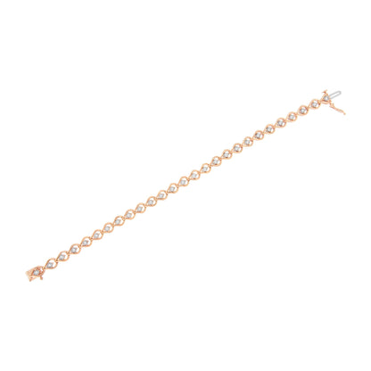 Rose-colored bracelet with round white gemstones in a miracle setting, shown in a flat lay angled view.