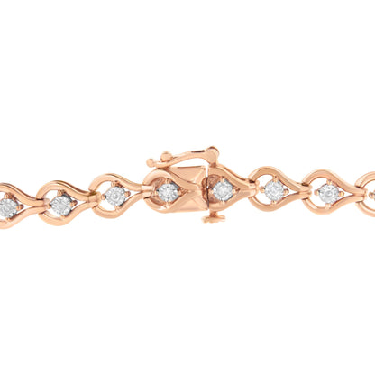 Close-up front view of a rose-colored bracelet with linked wave-shaped sections each set with a round white gemstone, shown on a white background.