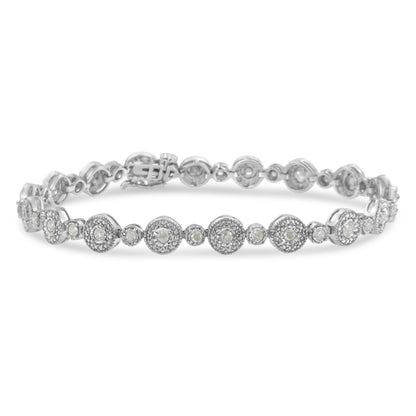 White metal bracelet with alternating small and larger round settings, each featuring white gemstones, shot at a slight top-front angle.