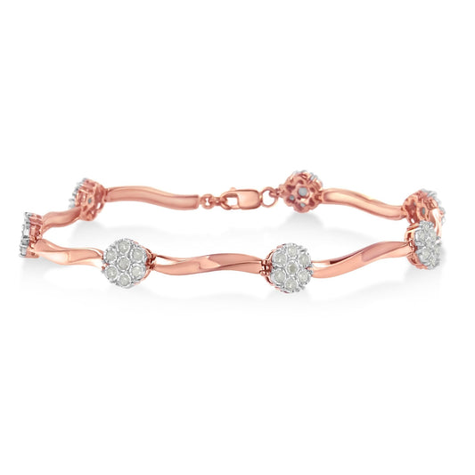 Rose metal bracelet with round white gemstones in prong settings, shown in a side angle view.
