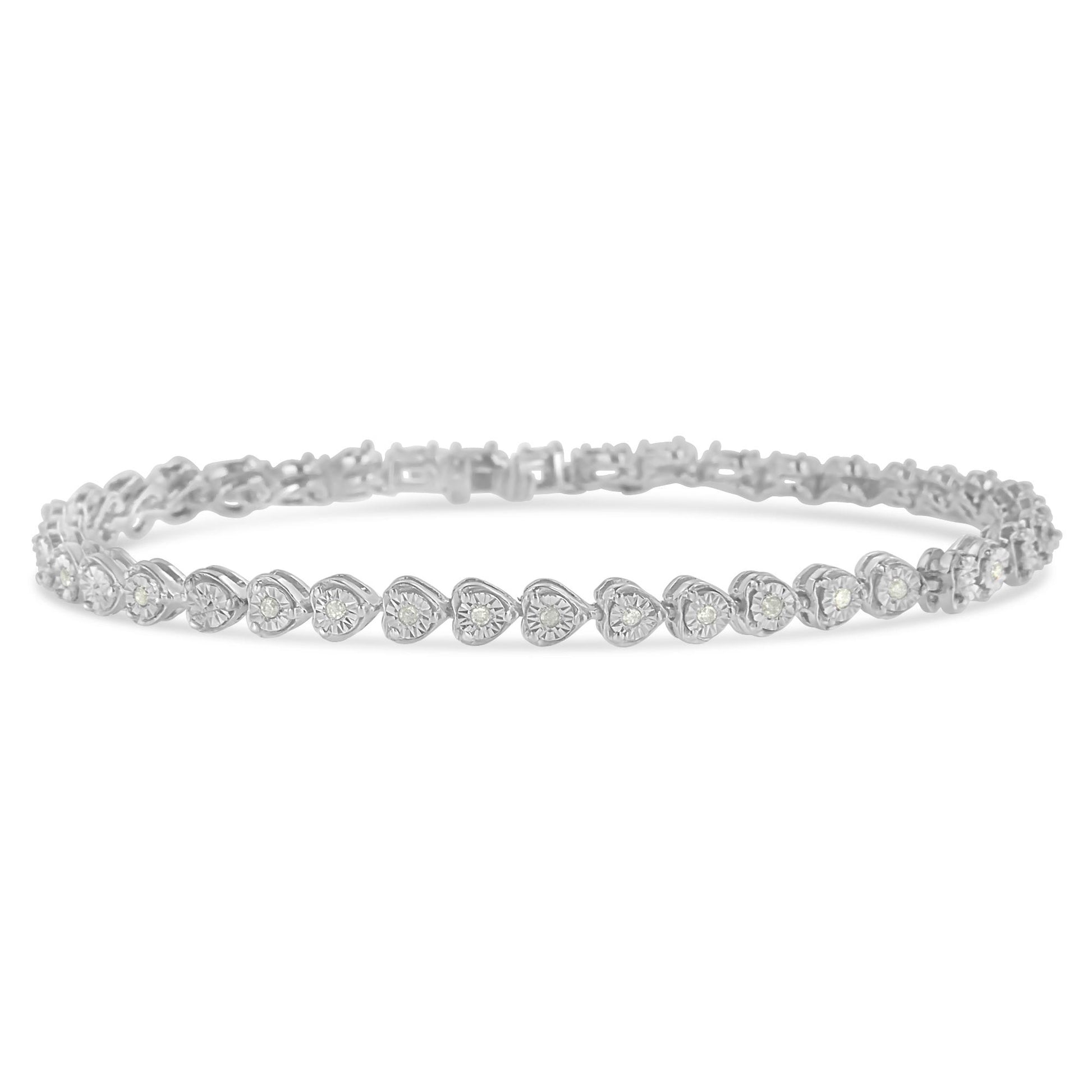 White metal bracelet with heart-shaped links each set with a round white gemstone in a miracle setting, shown in a close-up frontal angle.