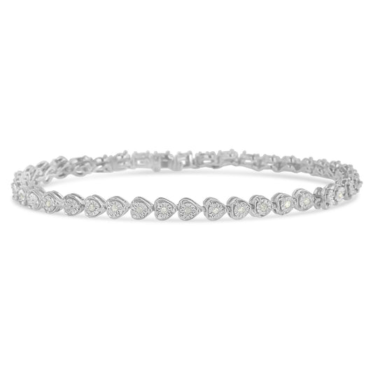 White metal bracelet with heart-shaped links each set with a round white gemstone in a miracle setting, shown in a close-up frontal angle.