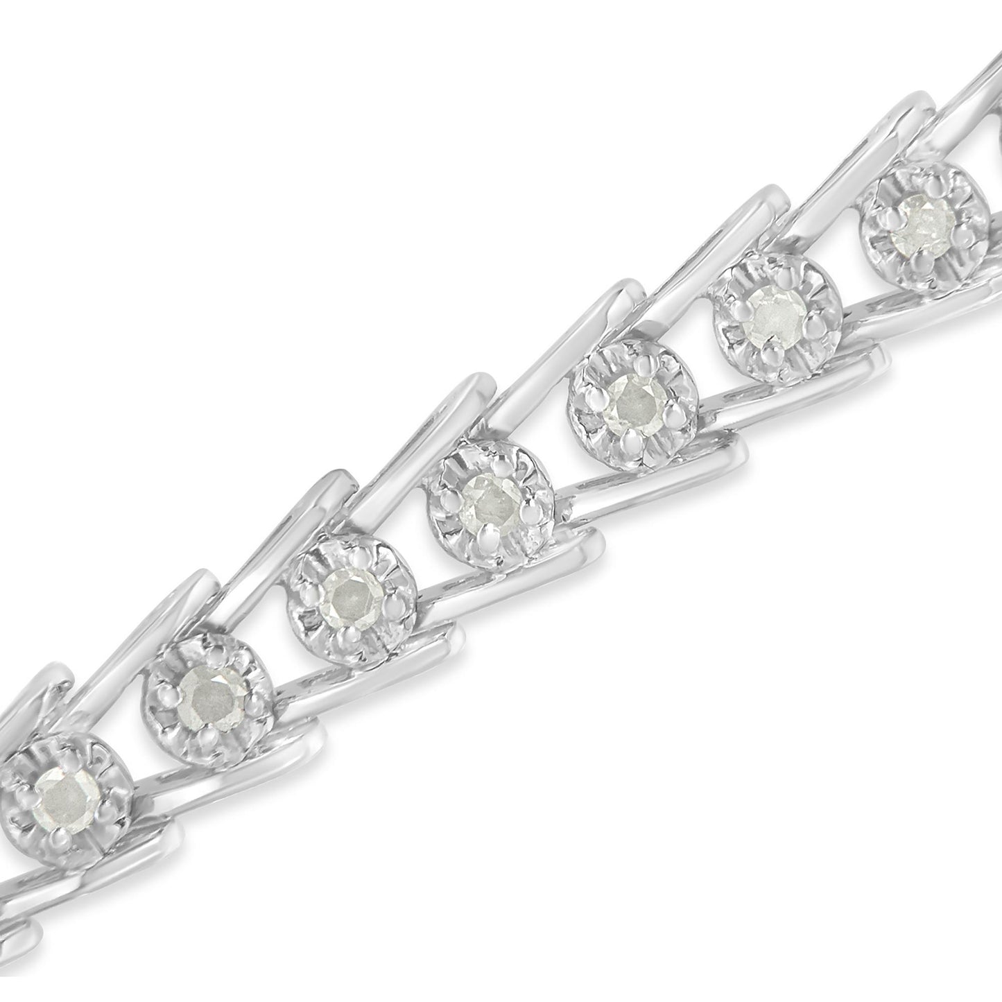 Close-up diagonal view of a white metal bracelet with round white gemstones in prong settings.