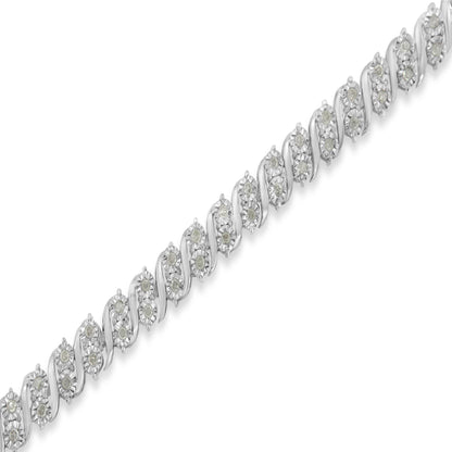 Diagonal close-up of a white metal bracelet featuring round white gemstones in a miracle setting.