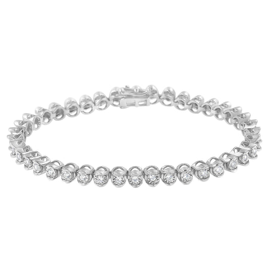 Close-up front angle of a white metal bracelet with round white gemstones in miracle setting.