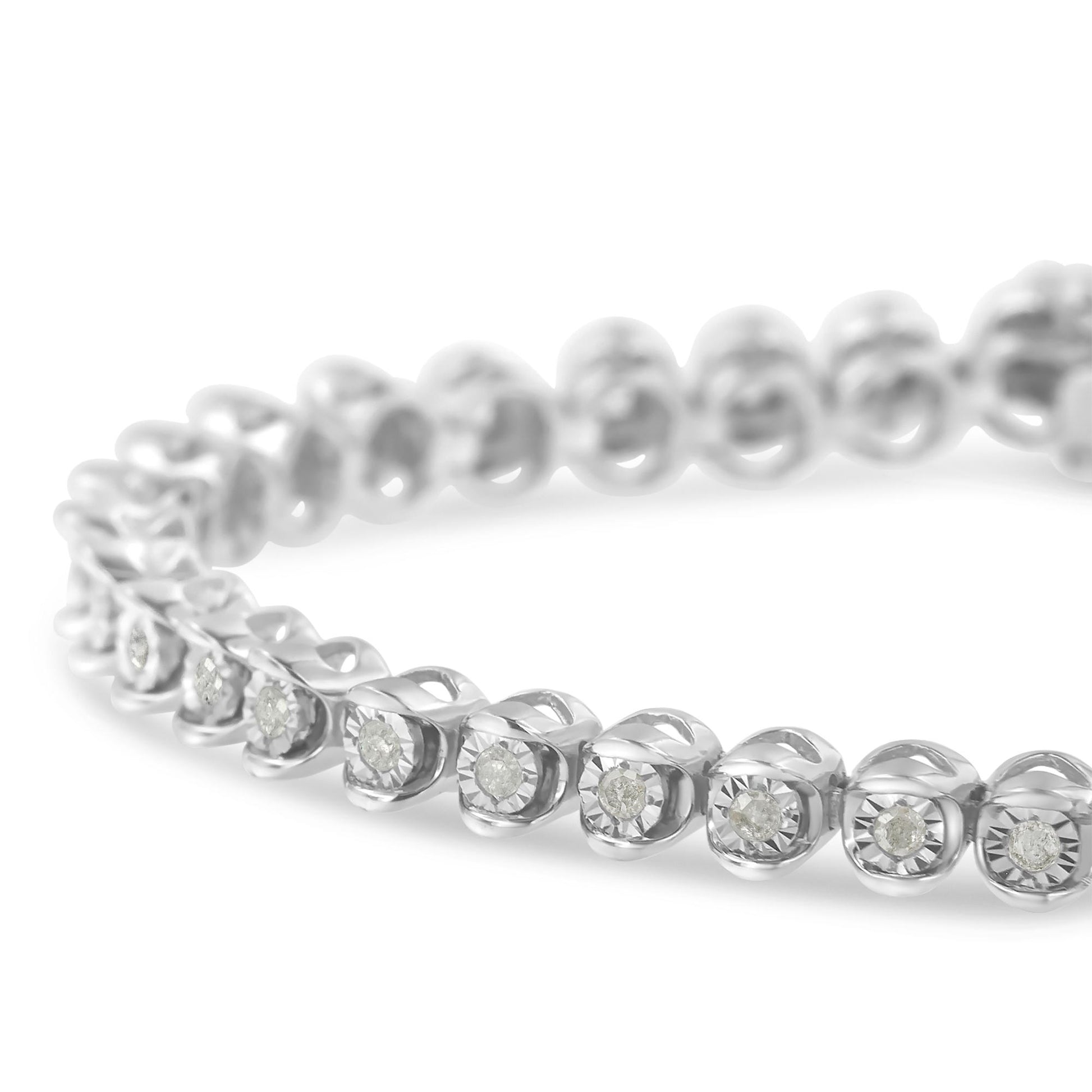 Close-up angled view of a white metal bracelet featuring round white gemstones in a miracle setting.