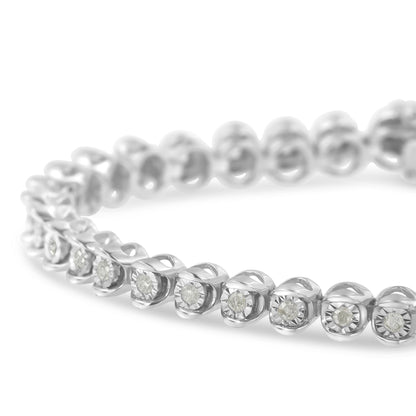 Close-up angled view of a white metal bracelet featuring round white gemstones in a miracle setting.