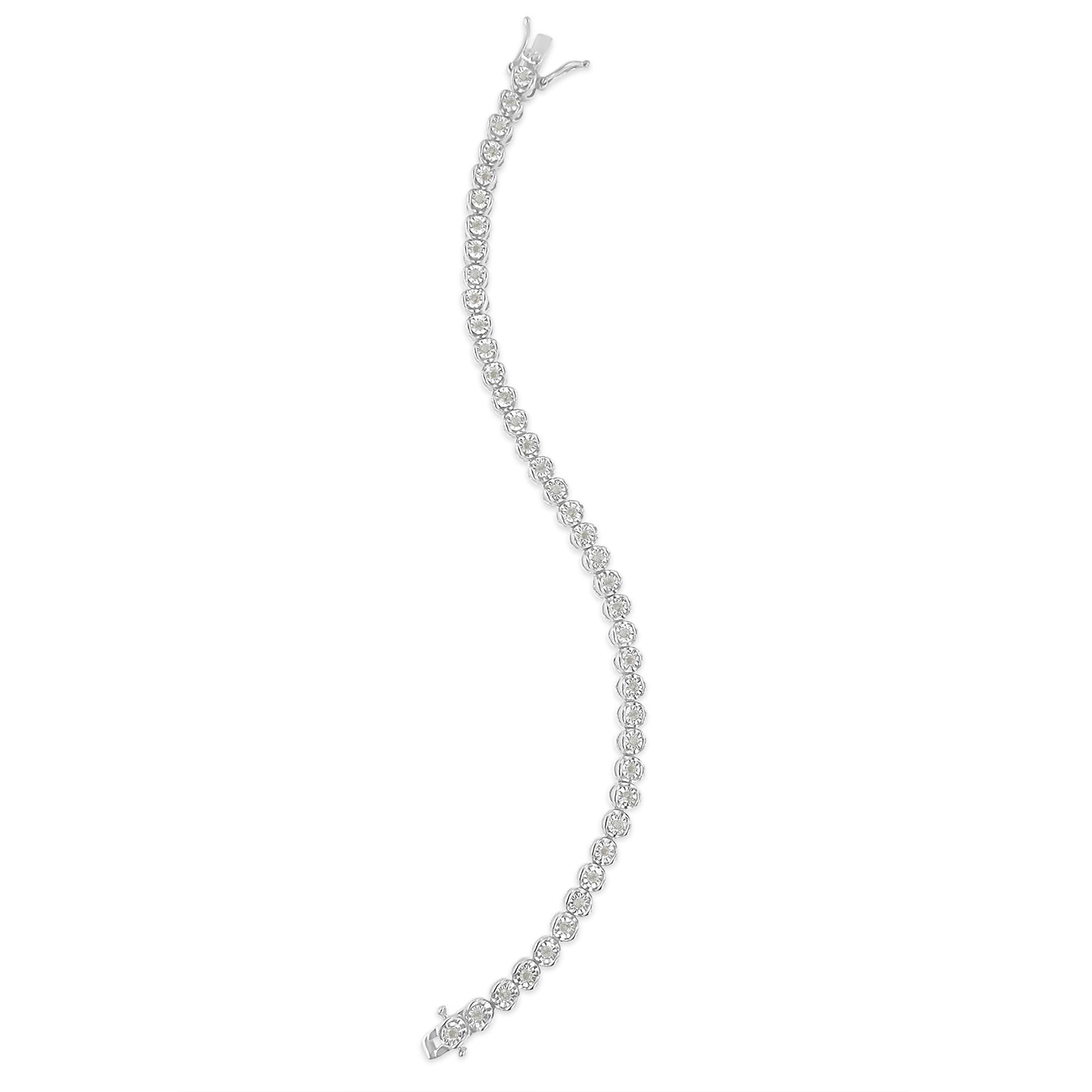 Curved white bracelet with round white gemstones in a miracle setting, photographed from above.