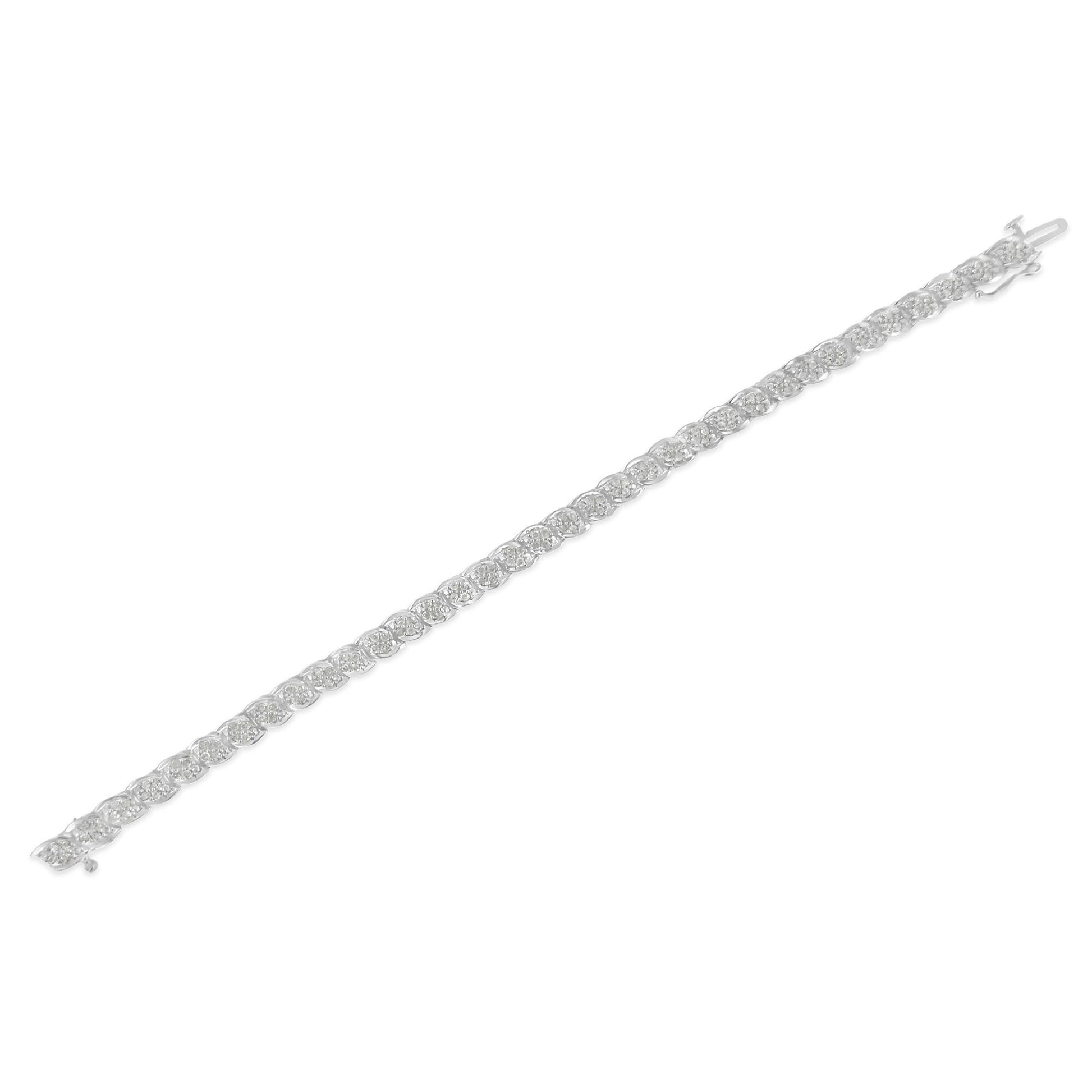 White metal bracelet with round white gemstones in prong settings, shown in a diagonal flat lay angle.
