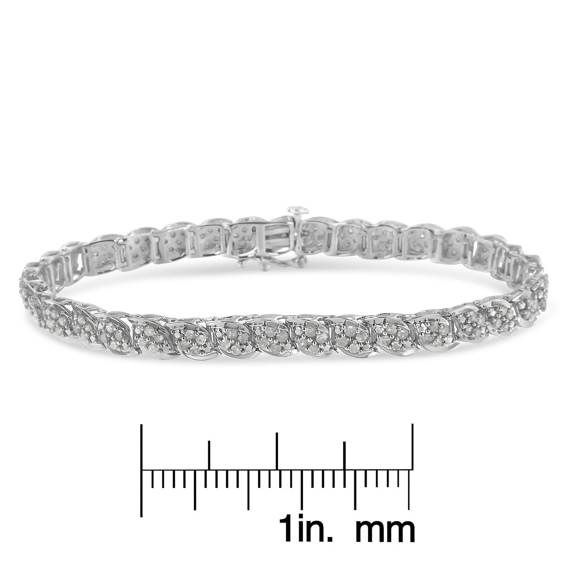 White metal bracelet with round white gemstones in prong settings, shown from a front angle above a ruler for size reference.