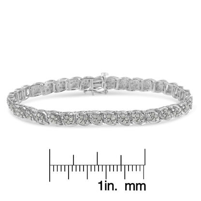 White metal bracelet with round white gemstones in prong settings, shown from a front angle above a ruler for size reference.