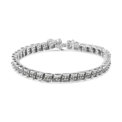 White metal bracelet with squares of pave-set round white gemstones, shown from front angle on a white background.