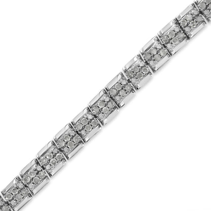 Close-up, angled view of a white metal bracelet with multiple linked sections, each featuring round white gemstones in a pave setting.
