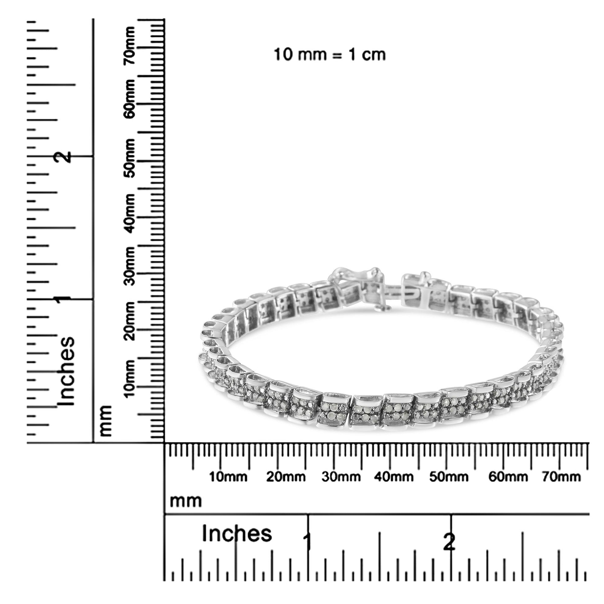 White metal bracelet with round white gemstones in pave setting, shown in a side angle shot on a ruler for size reference.