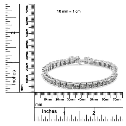 White metal bracelet with round white gemstones in pave setting, shown in a side angle shot on a ruler for size reference.