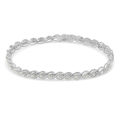 Bracelet with white metal chain and round white gemstones in a miracle setting, shown from a top angle.