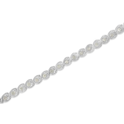 White metal bracelet with round white gemstones in miracle settings, shown in a diagonal close-up view.