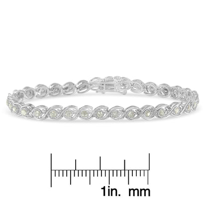 White metal bracelet with round white gemstones in a twisted design, shown in a front angle view, placed above a ruler for size reference.