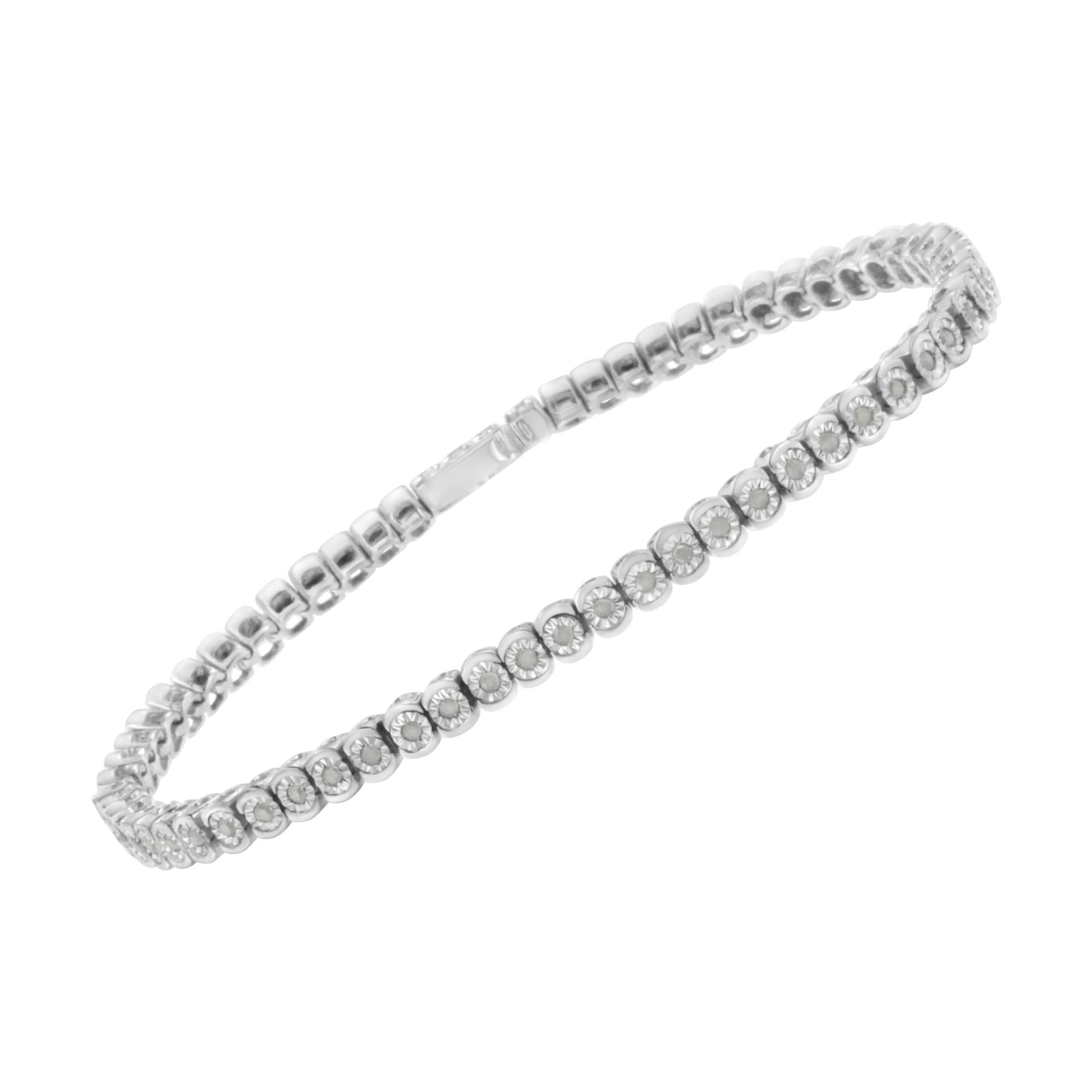 Angled top view of a white metal bracelet with round white gemstones set in a continuous pattern.