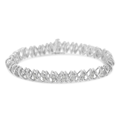 White metal bracelet with an X-shaped design featuring round white gemstones in a miracle setting, shown in a close-up angled front view.