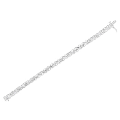 White metal bracelet with alternating round and baguette-shaped white gemstones, shown in a diagonal flat lay angle.
