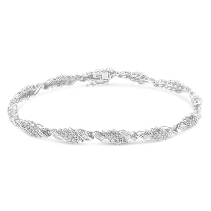 White metal bracelet with alternating sections of round pave-set white gemstones and baguette channel-set white gemstones, shown in a flat lay from a slightly elevated angle.